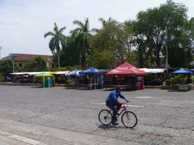 Santa Fé de Antioquia As he rides by, behind him, the Saturday market in Santa Fé de Antioquia is almost ready for business.