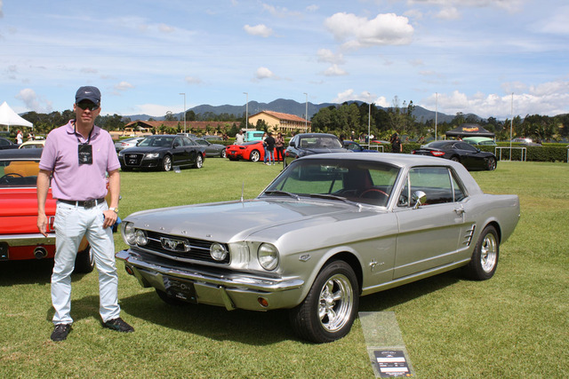 1966 Mustang Nicolas Pelaez stands next to the 1966 Mustang that used to belong to his great grandfather.