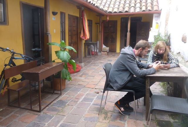 Alegria's Hostel Two visitors at Alegria's Hostel enjoy some leisure time in the beautiful courtyard.