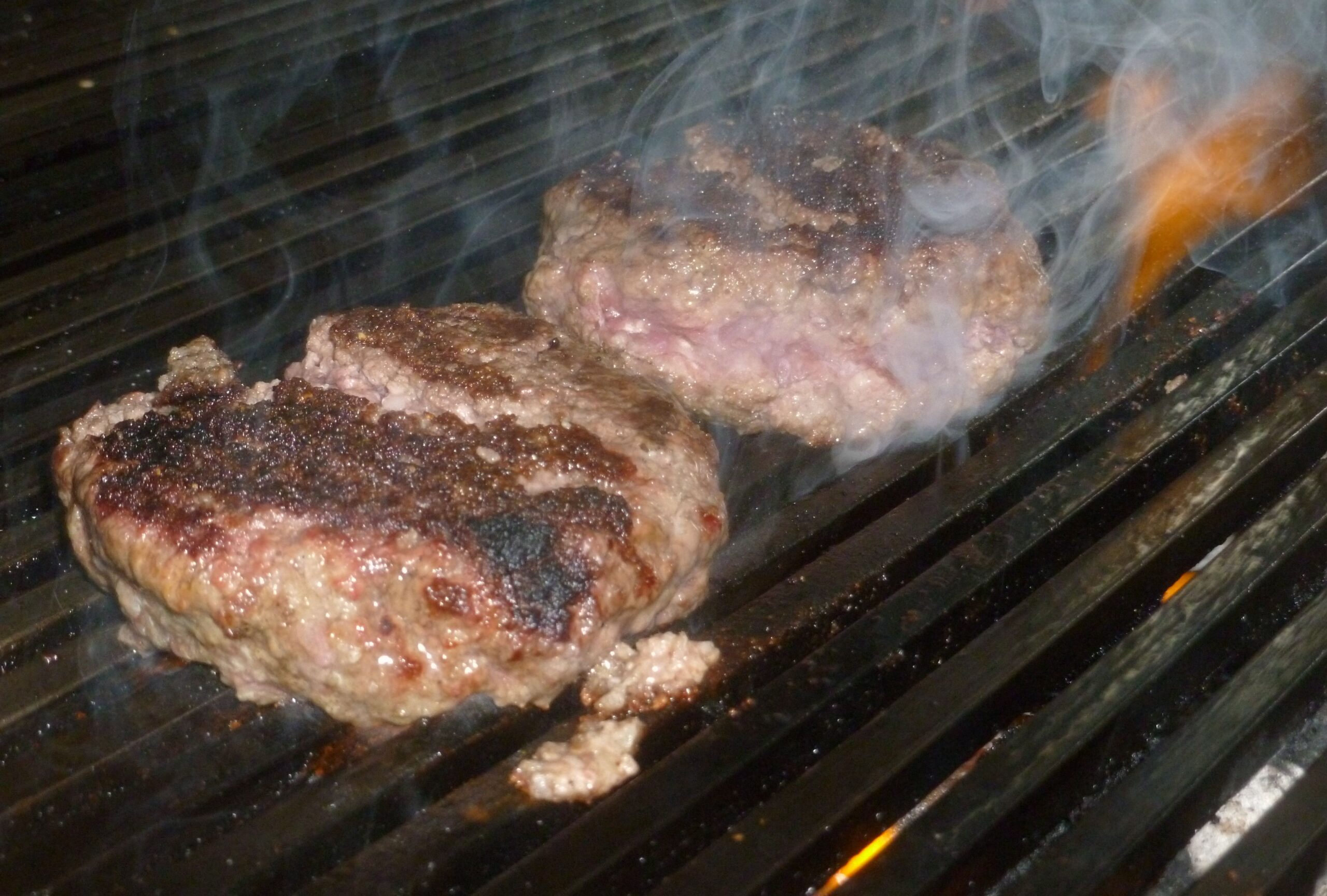 Burgers on the grill Steven, the owner, rocks the grill at London Burger Kitchen.