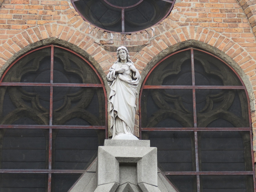 Statue Statue up high in the front of the church