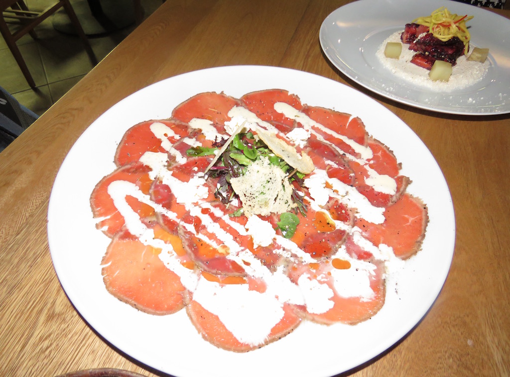 Bellota ham appetizer and in background the Octopus with popcorn appetizer