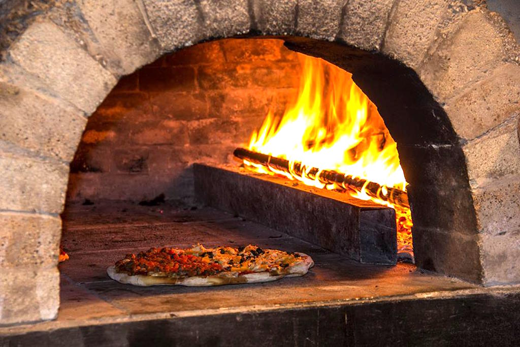 Pizza cocida en horno de ladrillo en Pizza en Leña, foto cortesía de Pizza en Leña