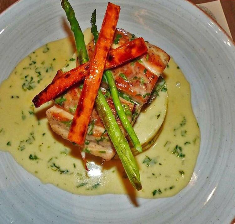 Salmon with mashed potatoes, carrots, asparagus, and lemon sauce