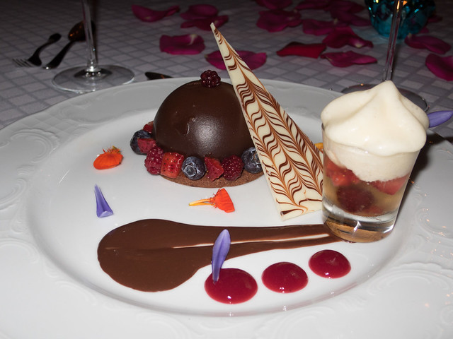 Semisphere of chocolate mousse with berries, and a shot of red fruit in Cosecha Tardía (wine) topped with mint foam