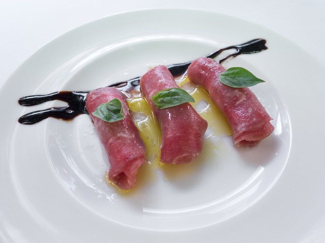 Beef carpaccio Beef carpaccio with cheese, basil, olive oil and balsamic vinegar