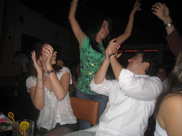 Rodrigo and his sister (standing) enjoying the night Rodrigo claps along with his sister (standing)