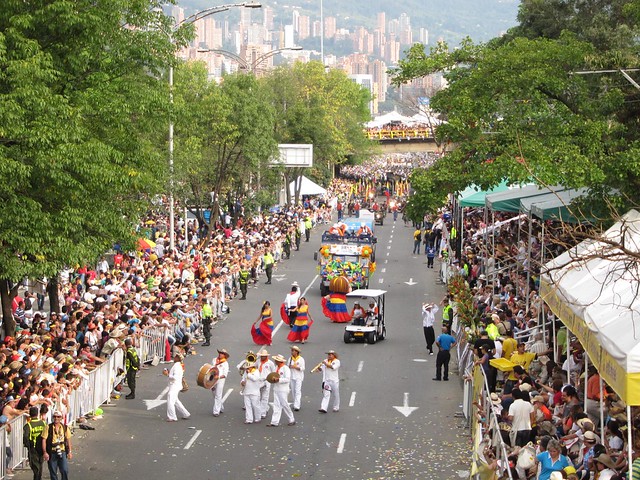 A marching band and women wearing the colors of the Colombian flag. A marching band and women wearing the colors of the Colombian flag.