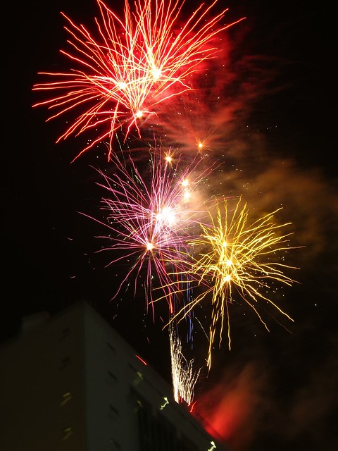 Fireworks explode over a government building. Fireworks explode over a government building.