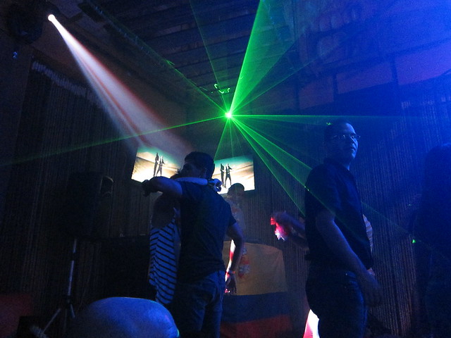 Green lasers shoot out from above the DJ booth. Green lasers shoot out from above the DJ booth.