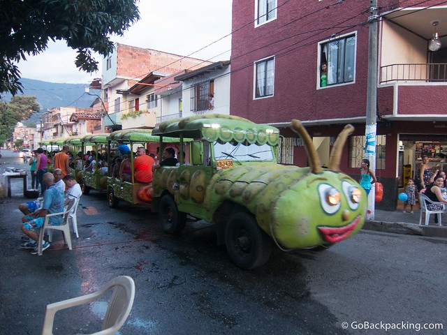 Kids ride A jeep disguised as a caterpillar pulls kids through the neighborhood streets