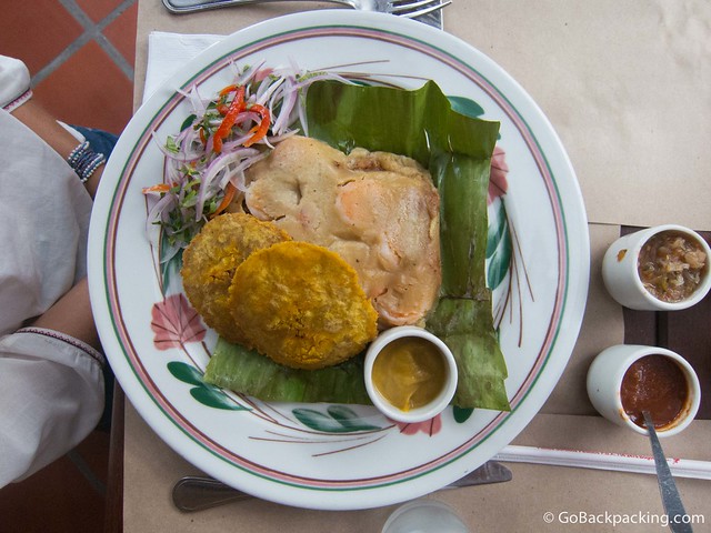 Tamal de Guapi Tamale filled with fish, shrimp, coconut and spices, with a side of salsa de lulo